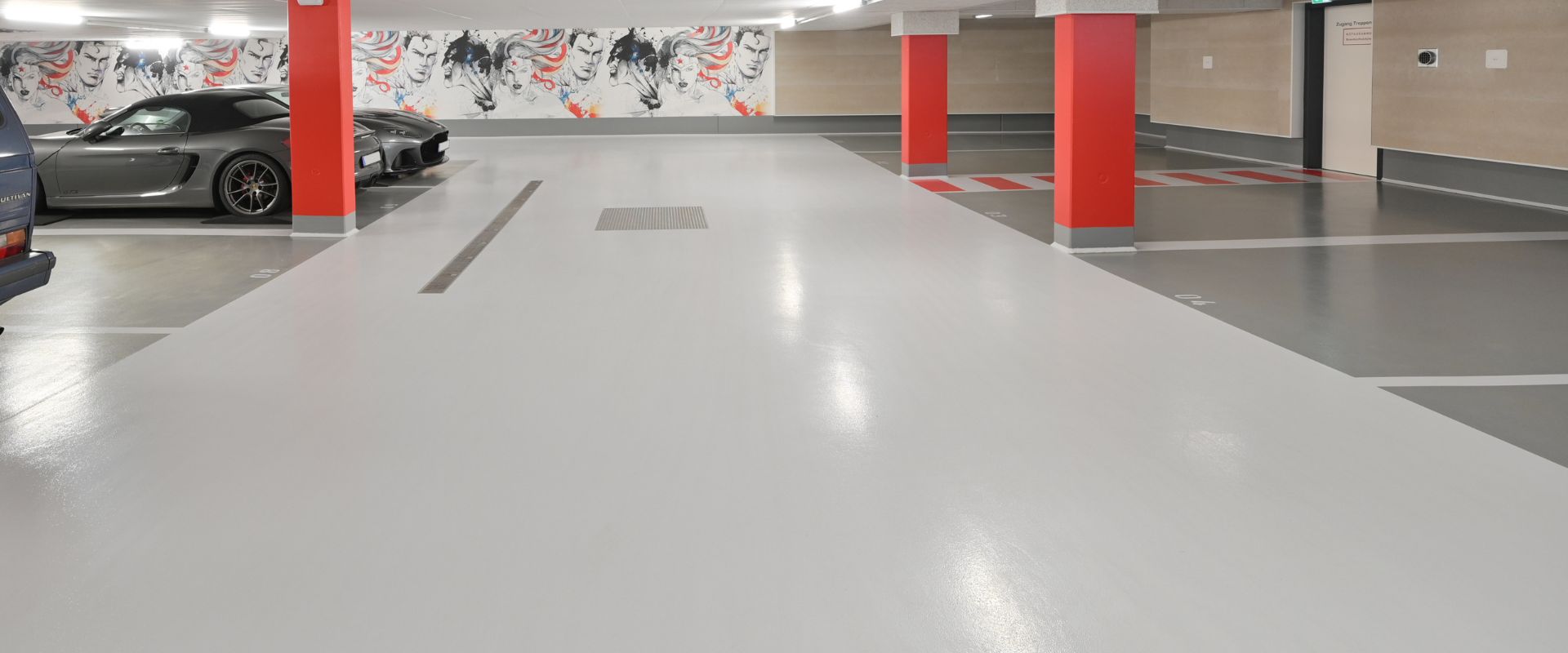 View of the artfully designed underground car park in Ingolstadt with depictions of comic book superheroes on the walls.